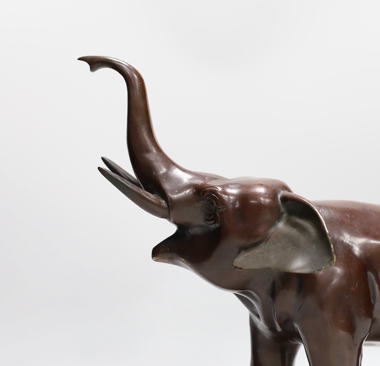A 20th century patinated bronze model of an elephant, 29cm tall